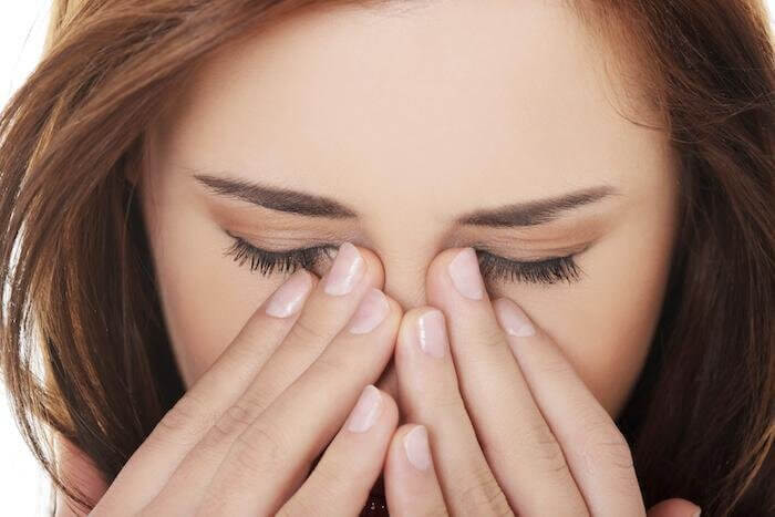 Woman rubbing her eyes